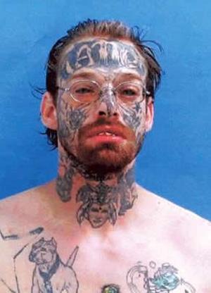 Michael “Tattoo” Knuth. Witness, the jail mugshot (above) of Logan County, 